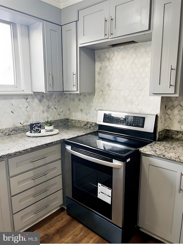 kitchen featuring light stone countertops, gray cabinets, dark hardwood / wood-style flooring, and stainless steel electric range