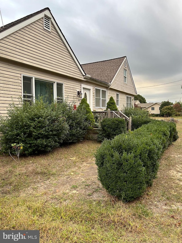 view of property exterior with a deck