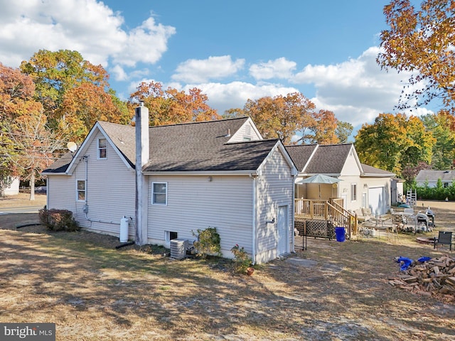 rear view of property featuring central air condition unit