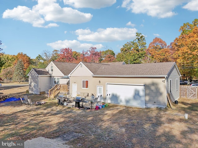 back of house with an outdoor structure and a garage