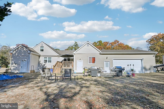 back of property with a garage