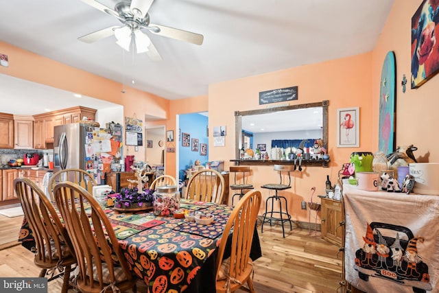 dining space featuring light hardwood / wood-style floors and ceiling fan