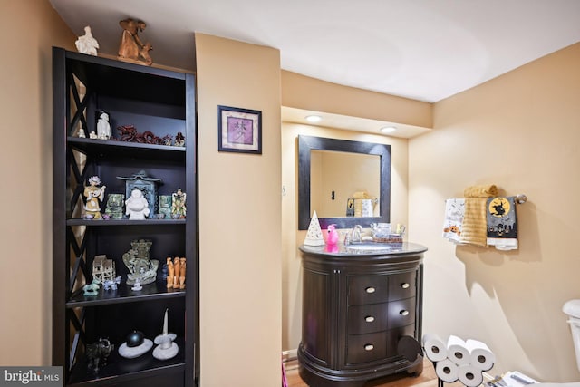 bathroom featuring vanity, hardwood / wood-style flooring, and toilet