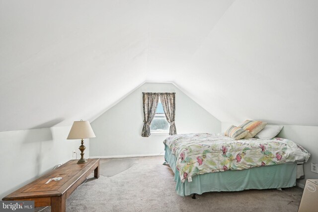 carpeted bedroom with lofted ceiling