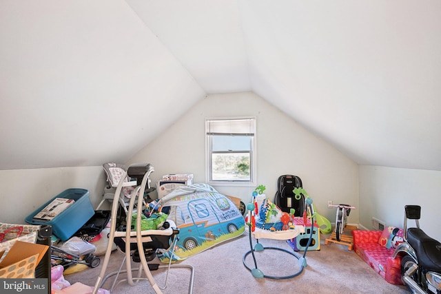 bedroom with vaulted ceiling and carpet floors