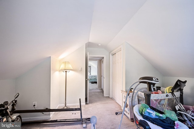 interior space featuring lofted ceiling and carpet floors