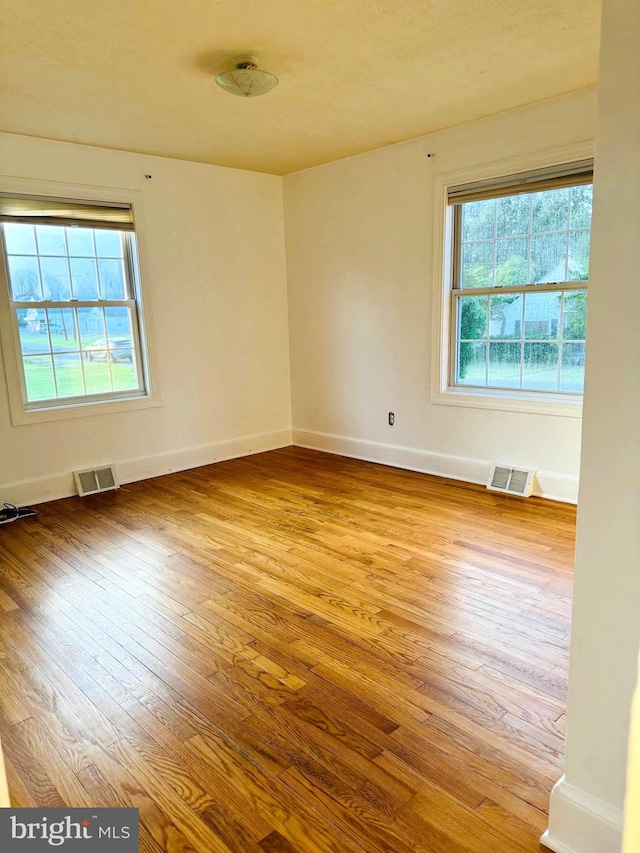 unfurnished room with light hardwood / wood-style floors