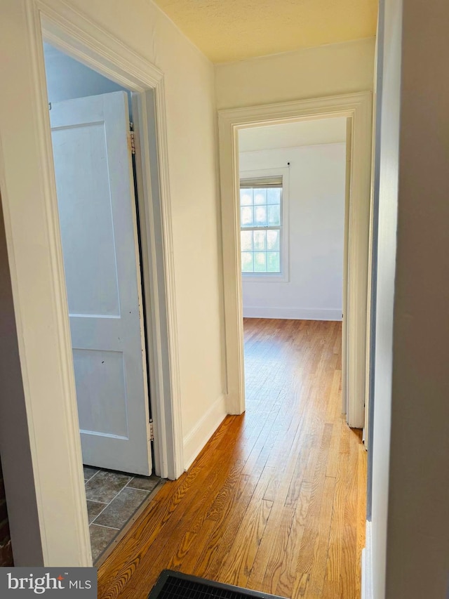 hall with hardwood / wood-style floors