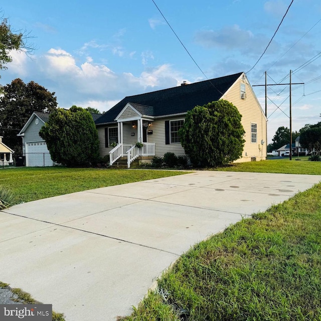 view of front of property featuring a front yard and a garage