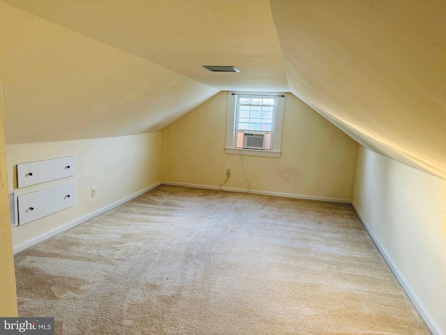 additional living space with light carpet, cooling unit, and lofted ceiling