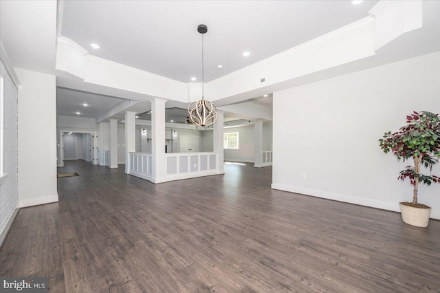 unfurnished dining area with ornate columns and dark hardwood / wood-style flooring