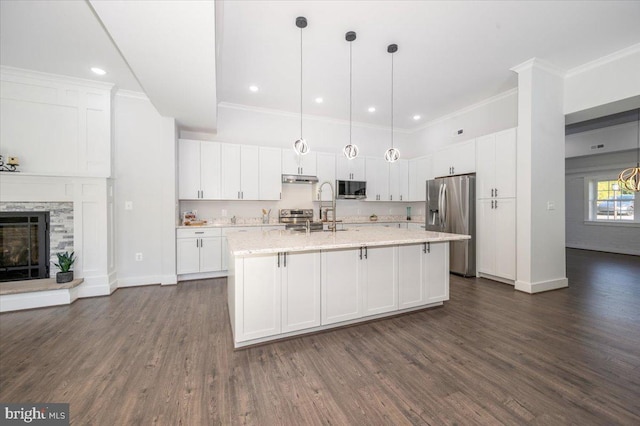 kitchen with dark hardwood / wood-style flooring, stainless steel appliances, and white cabinets