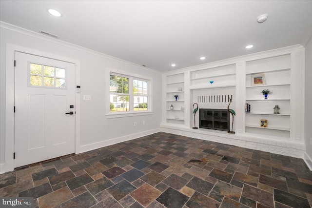 unfurnished living room with a brick fireplace, ornamental molding, built in features, and a wealth of natural light