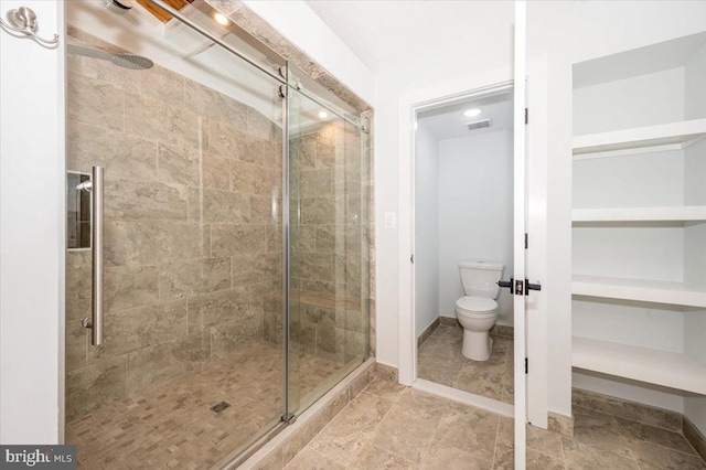 bathroom with walk in shower and toilet