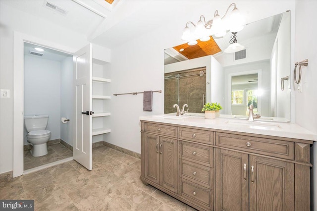 bathroom with walk in shower, vanity, and toilet