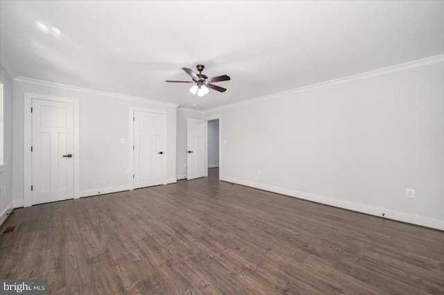 interior space with dark wood-type flooring, crown molding, multiple closets, and ceiling fan