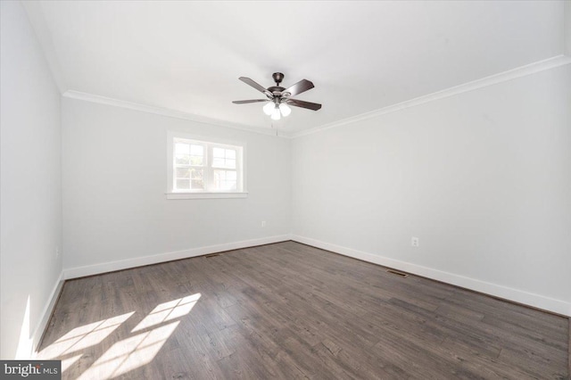 empty room with crown molding, ceiling fan, and dark wood-type flooring