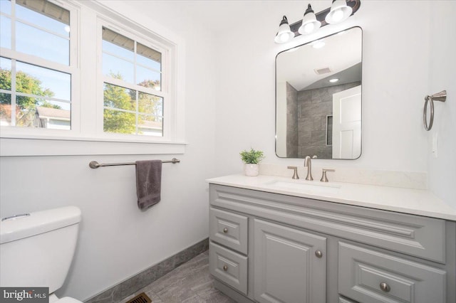 bathroom with vanity, toilet, and tile patterned floors