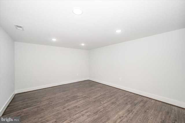 unfurnished room featuring dark hardwood / wood-style flooring