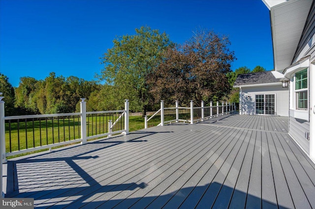 wooden deck featuring a yard