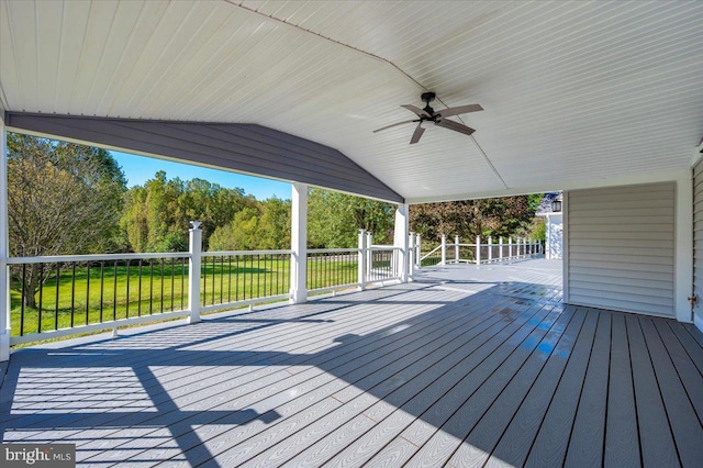 deck with a lawn and ceiling fan