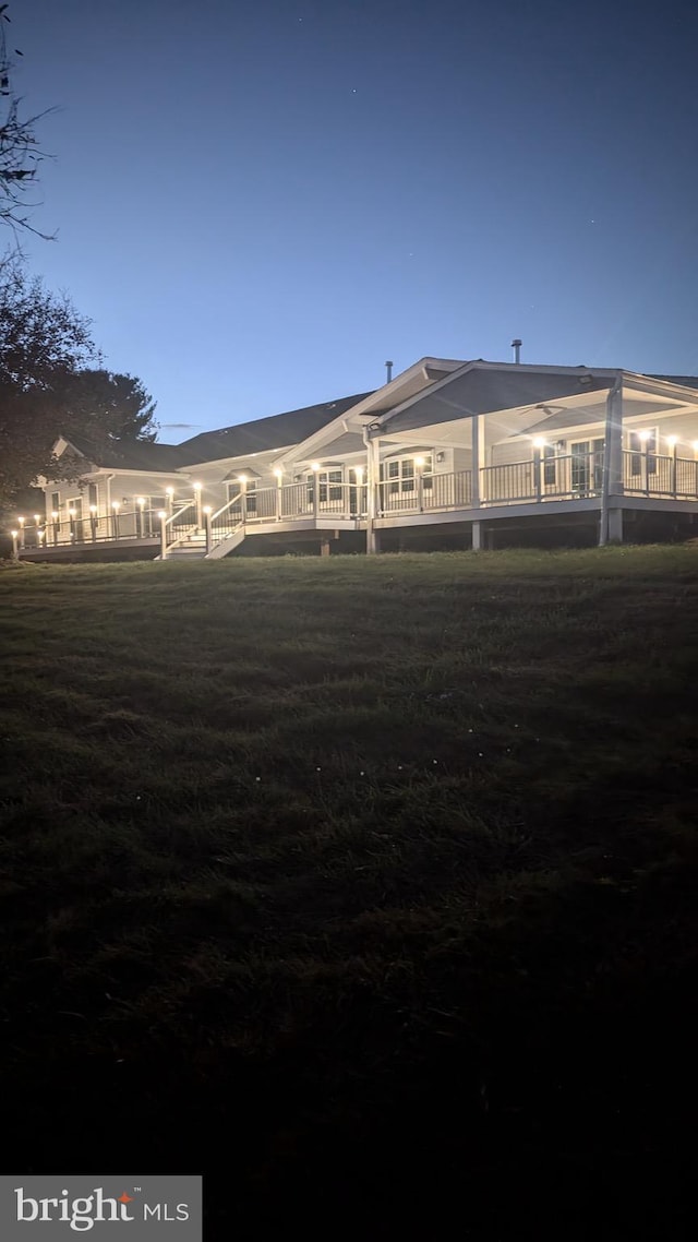 view of back house at dusk