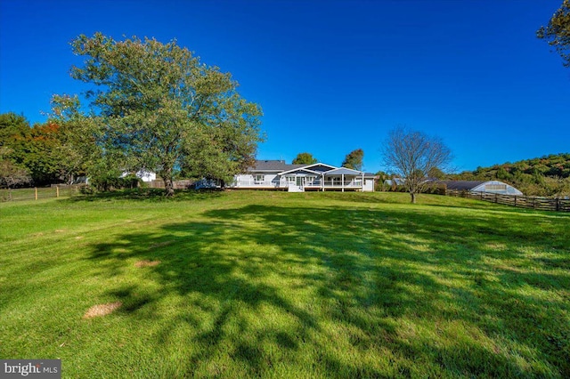 view of yard with a rural view