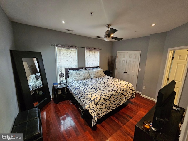 bedroom featuring ceiling fan, a closet, and dark hardwood / wood-style flooring