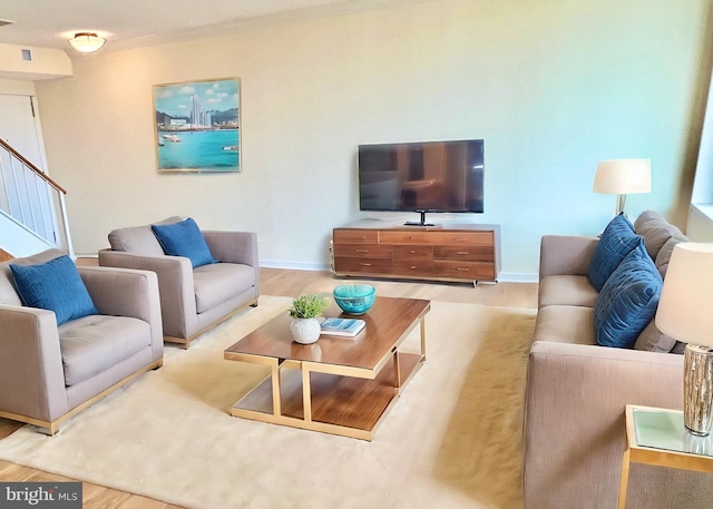 430 M St SW Unit N708, Washington, DC 20024 - living room with wood finished floors, baseboards, and stairway
