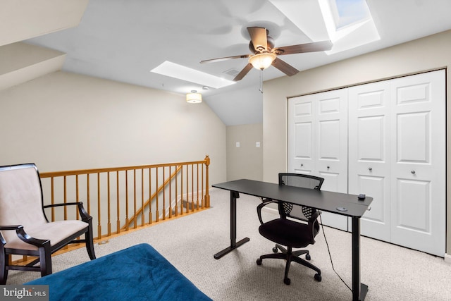 carpeted office with lofted ceiling with skylight and ceiling fan