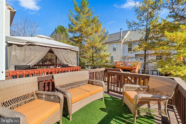 wooden terrace featuring a gazebo