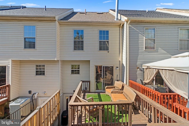 back of house featuring a deck