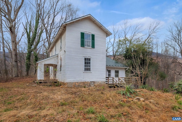 view of property exterior featuring a deck