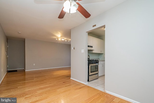 interior space with light wood-type flooring and ceiling fan