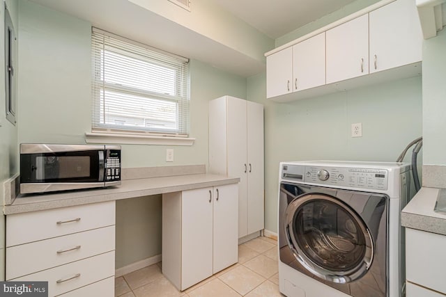 laundry room with light tile patterned floors and washer / clothes dryer