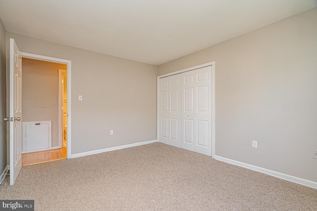 unfurnished bedroom featuring carpet floors and a closet