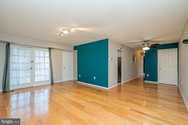 unfurnished room featuring ceiling fan, light hardwood / wood-style flooring, and french doors