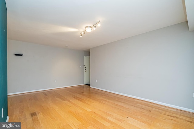 unfurnished room with hardwood / wood-style flooring