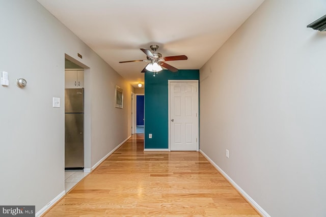 interior space with ceiling fan and light hardwood / wood-style floors