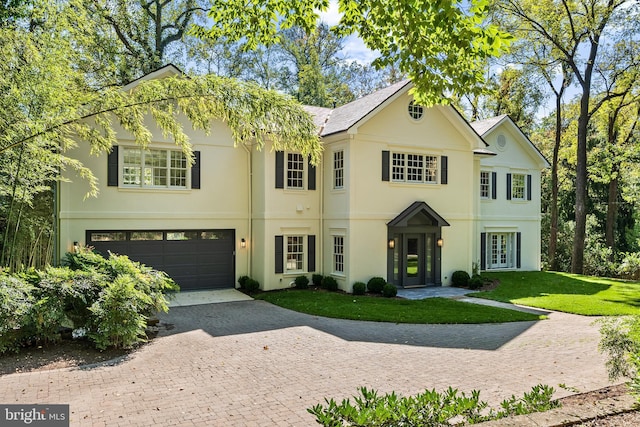 view of front of house with a garage and a front yard