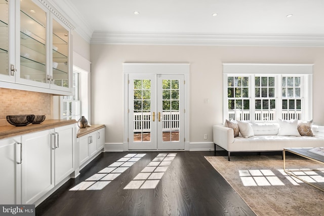 doorway with french doors, dark hardwood / wood-style flooring, and ornamental molding