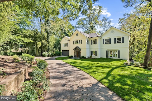 view of front facade featuring a front lawn and a garage