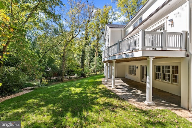 view of yard featuring a patio and a wooden deck