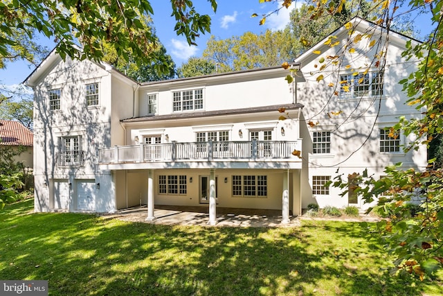 back of house with a yard, a patio, a garage, and a deck