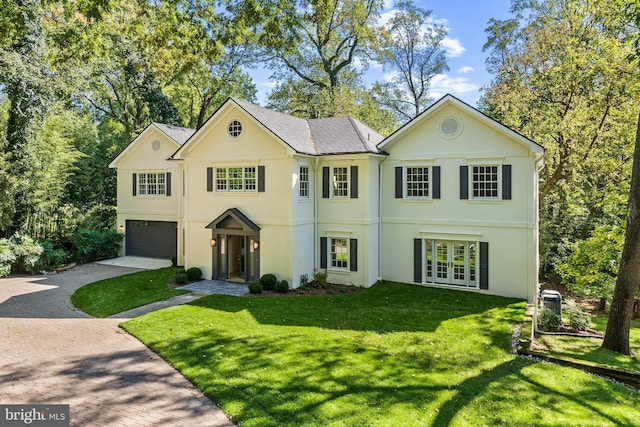 view of front of home featuring a front yard and a garage