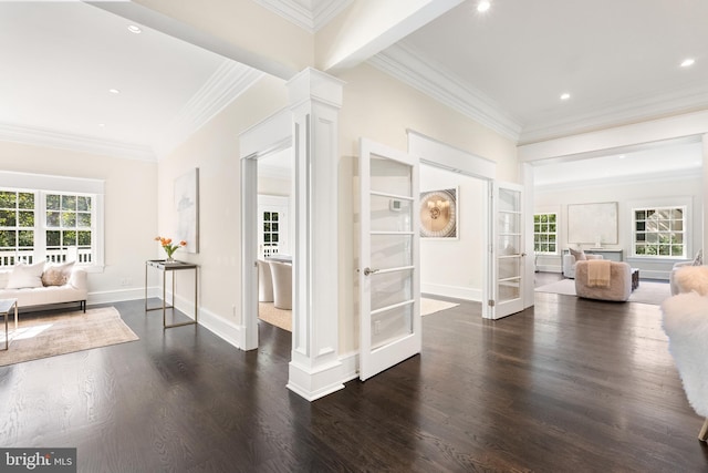 corridor with dark hardwood / wood-style floors, ornate columns, ornamental molding, and french doors