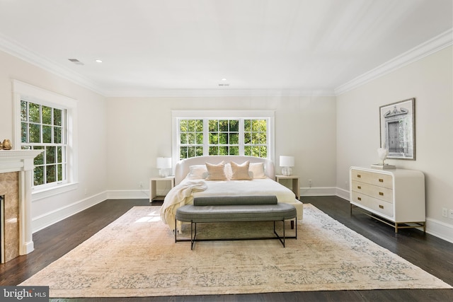 bedroom featuring dark wood-type flooring, multiple windows, and ornamental molding