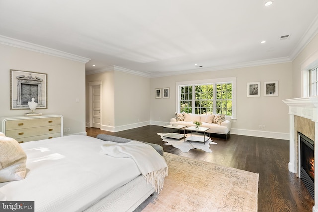 bedroom with dark hardwood / wood-style floors, ornamental molding, and a high end fireplace