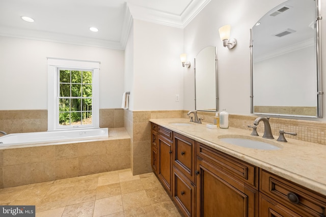 bathroom featuring vanity, tile walls, ornamental molding, and tiled tub