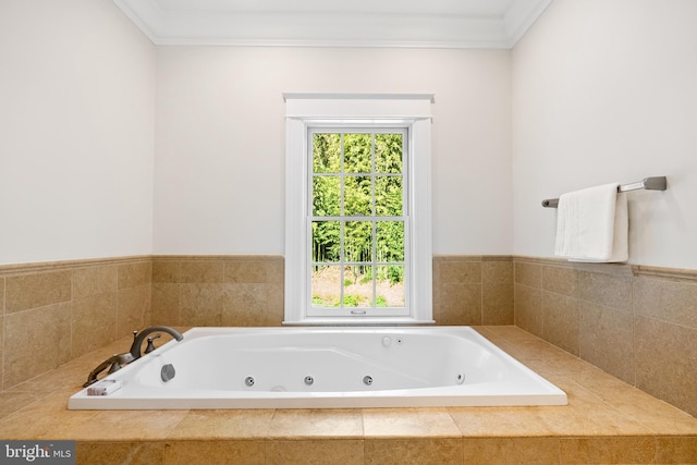 bathroom with tiled tub and ornamental molding